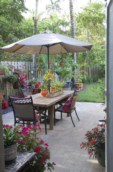 an outdoor dining area with patio furniture and potted plants