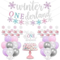 a birthday cake and balloons with the words winter onederland on it, surrounded by snowflakes