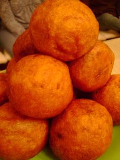 a pile of doughnuts sitting on top of a green plate