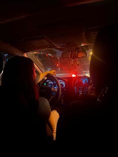 the interior of a car at night with its lights on and people sitting in it