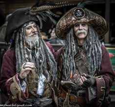 two men dressed in pirate costumes with dreadlocks