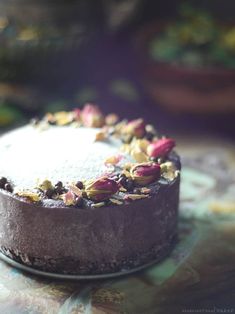 a chocolate cake with flowers on it sitting on a table