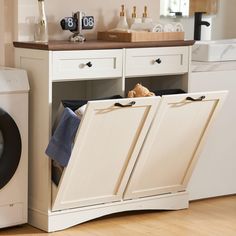 a laundry room with an open cabinet and washer