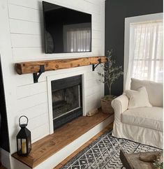 a living room with a tv mounted above the fireplace