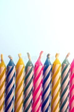 a row of brightly colored candles sitting next to each other