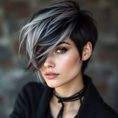 A woman with short, bold hair, dark black with gray strands, suggesting modernity and boldness. Her haircut shows the delicate features with a touch of strength, as the hair appears asymmetrically on one side, adding a touch of rebellion to her look. Her carefully styled hair reflects her independent personality Short Dark Hair Blonde Highlights, Silver And Black Hair Short, Black And Grey Hair Short, Grey Pixie Hair, Black And Silver Hair, Pixie Cut With Highlights, Grey Hair Roots, Black And Grey Hair