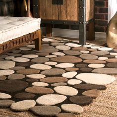 a brown and white area rug with circles on the floor in front of a bed