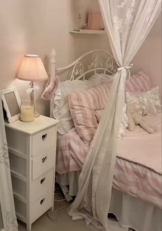 a white bed sitting next to a night stand