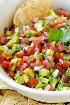 a salad with tomatoes, avocado and other vegetables