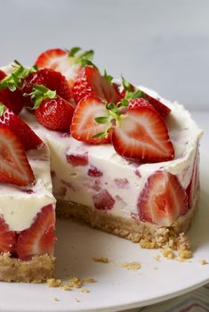 a cheesecake with strawberries is on a plate