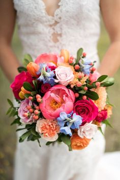 a woman holding a bouquet of flowers in her hands