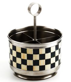 a black and white checkered container with a metal holder in the shape of a circle