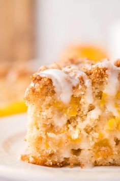 a close up of a piece of cake on a plate with lemons in the background