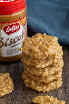 no bake cookies with cookie butter are stacked on top of each other in front of a jar of peanut butter