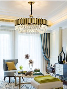 a living room filled with furniture and a chandelier hanging over the top of it