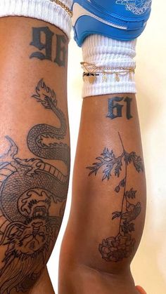 two people with tattoos on their legs