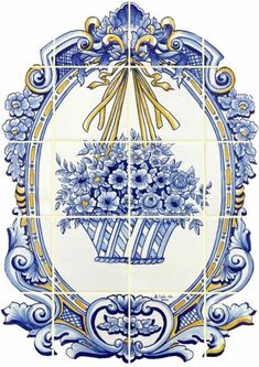 a blue and white tile with flowers in the center, surrounded by an ornate frame