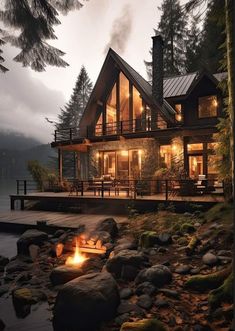 a house with a fire pit in front of it on the side of a lake