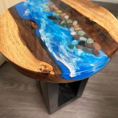 a wooden table with blue and black paint on it