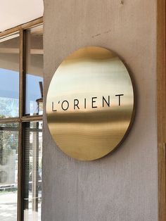 a sign on the side of a building that says lorient in black and gold