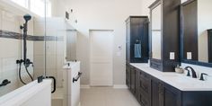 a large bathroom with two sinks and mirrors