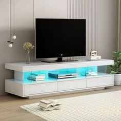 a flat screen tv sitting on top of a white entertainment center