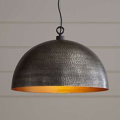 an industrial style pendant light hanging from a ceiling fixture with wood accents and metal finish