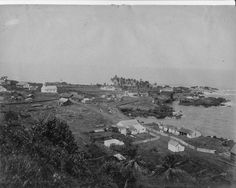 an old black and white photo of a town by the ocean