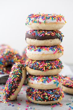 a stack of doughnuts with sprinkles and chocolate