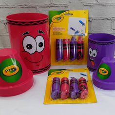 children's crayon cups and markers are on the table with other items