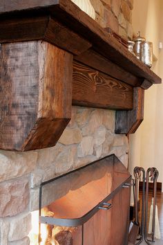 the fireplace is made from wood and stone