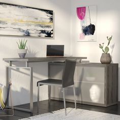 a desk with a laptop computer on top of it next to a chair and potted plant