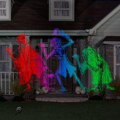 three animated figures are projected on the side of a house