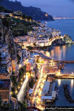 an aerial view of a city by the water at night