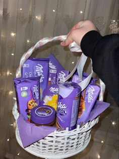 a person holding a basket filled with chocolates