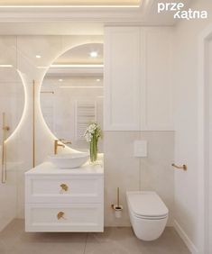 a bathroom with a sink, toilet and mirror in it's center wall is illuminated by recessed lighting