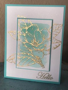 a card with gold foil flowers on it