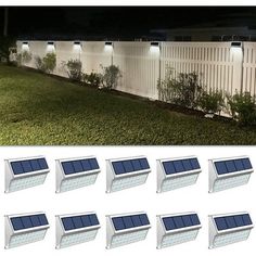 the solar powered lights are on in front of a white fence and grass area at night