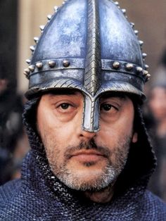 a close up of a man wearing a helmet with spikes on it's head