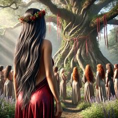 a woman with long hair standing in front of a group of other women under a large tree