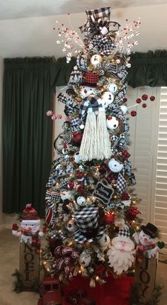 a christmas tree decorated with ornaments and ribbons