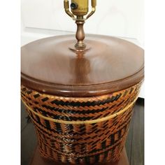 a brown and black basket sitting on top of a wooden table