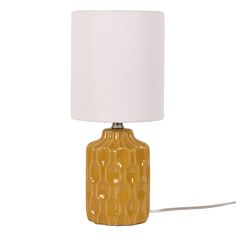 a yellow table lamp with a white shade on the base and a cord attached to it