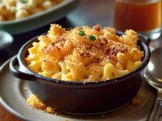 macaroni and cheese is served in a black bowl