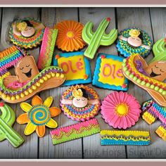 decorated cookies are arranged in the shape of sombrero and cactus hats, flowers, and other decorations