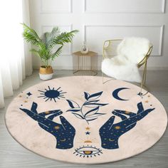 a rug with two hands holding stars and the moon above them, in front of a chair