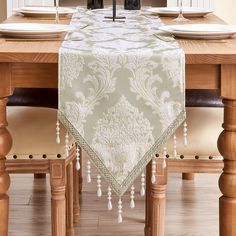 a dining room table set with place settings