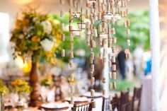 a chandelier made out of wine corks hangs from the ceiling in a dining room