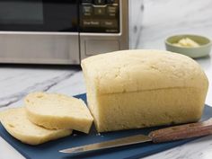 a loaf of bread sitting on top of a blue cutting board next to a knife