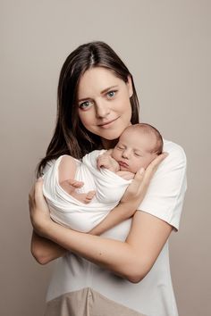 a woman holding a baby in her arms